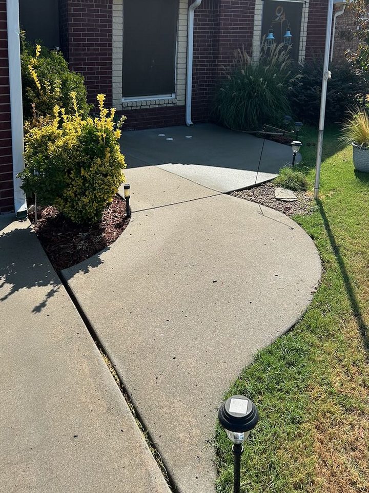The same curved front walk, even and light in color with the joint cleared, after cleaning